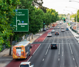 A bus travelling down the bus lane on Hoddle Street.