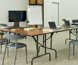Empty classroom with desks around a whiteboard