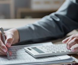 Person reading financial accounts and making calculations