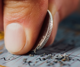 A person using a coin to scrat a lottery scratchcard 